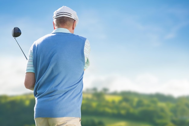 Rear view of man playing golf