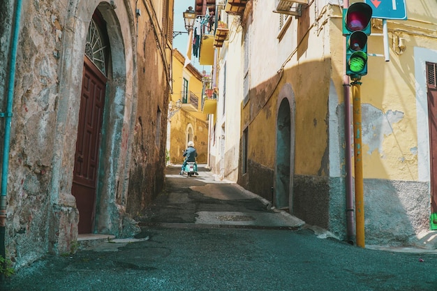 rear view of man riding motorcycle at alley