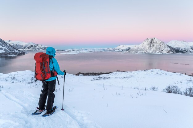 Rear view of man on snow covered landscape