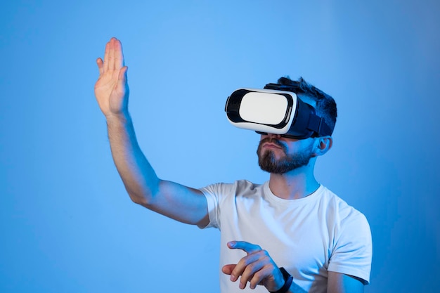 Rear view of man standing against blue background