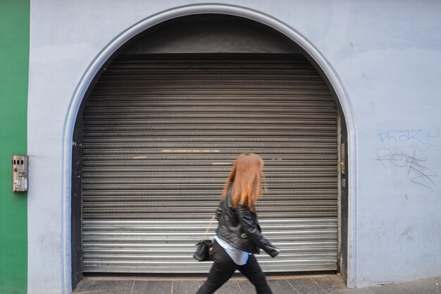 Rear view of man standing against closed door