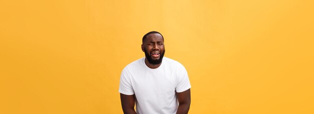 Rear view of man standing against yellow background