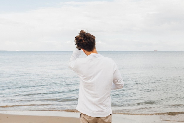 rear view of man standing on beach