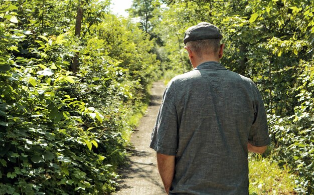 Rear view of a man standing by plants