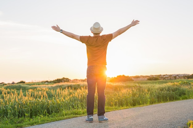 Photo rear view of man standing on field against sky