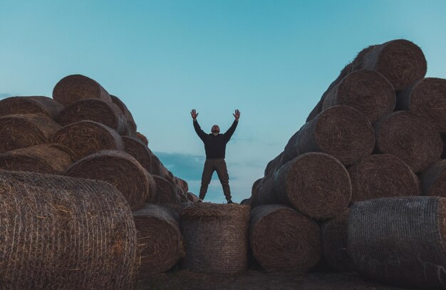 Rear view of man standing on rock against clear sky