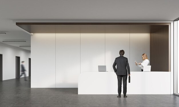 Rear view of man talking with receptionist