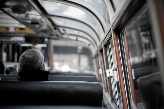 rear view of man traveling in train