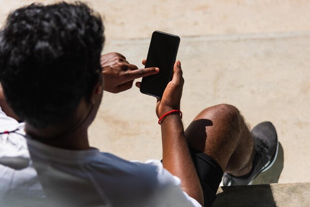 Rear view of man using mobile phone