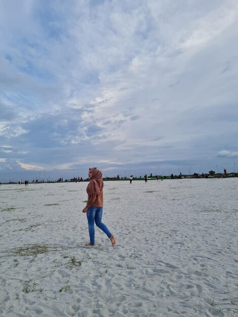 Rear view of man walking on beach