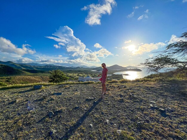 Rear view of man walking on field against sky on the margarita island in venezuela
