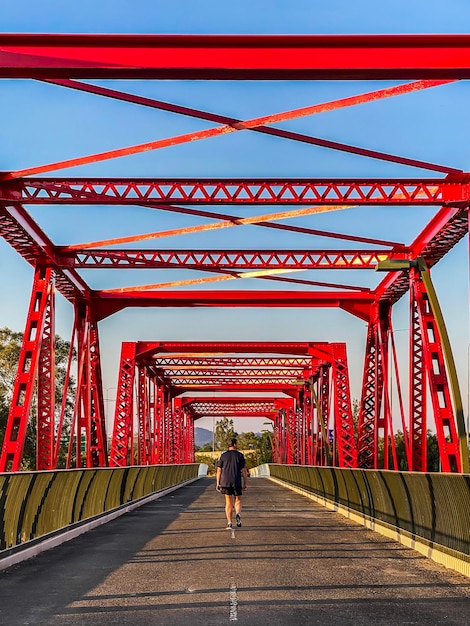 Foto vista posteriore di un uomo che cammina su un ponte pedonale