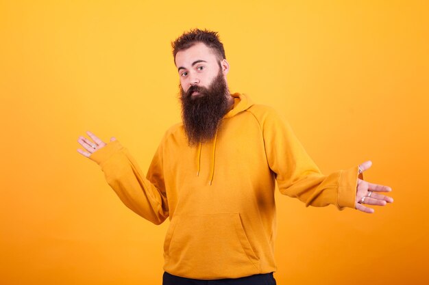 Rear view of man with arms crossed against yellow background