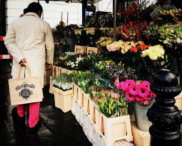 Rear view of man with flowers in store