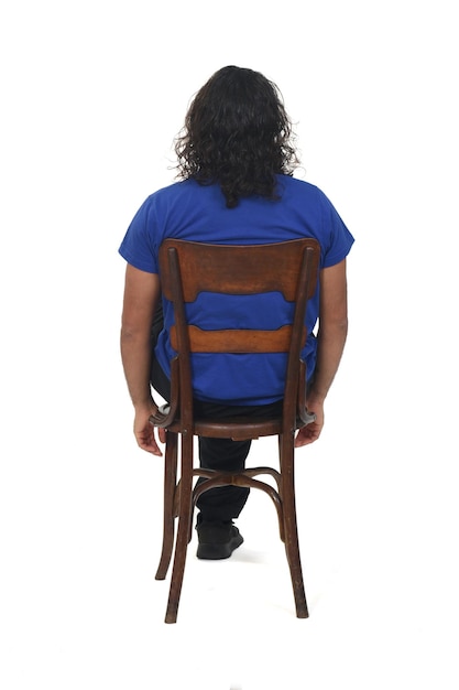 Rear view of a man with sportswear sitting on chair on white background