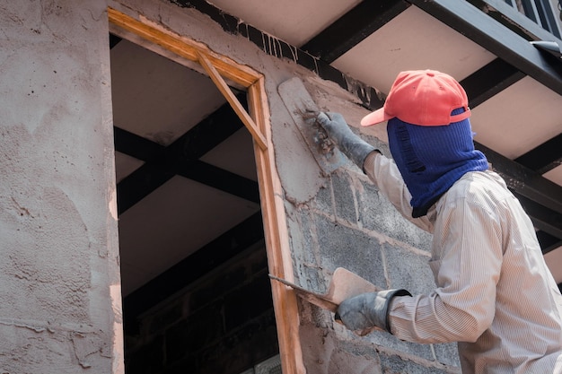 Photo rear view of man working on building