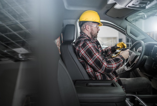 Rear view of man working in car