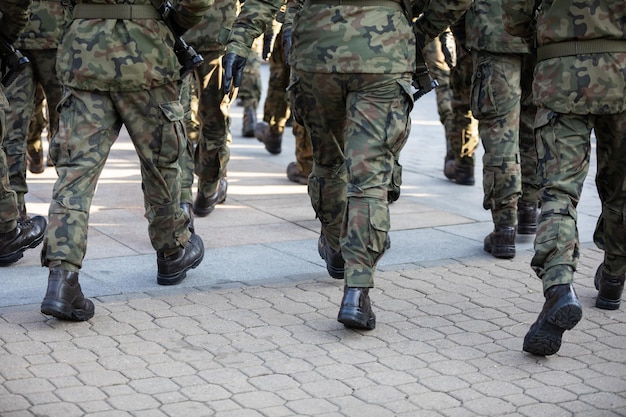 rear view of marching soldiers in full uniform