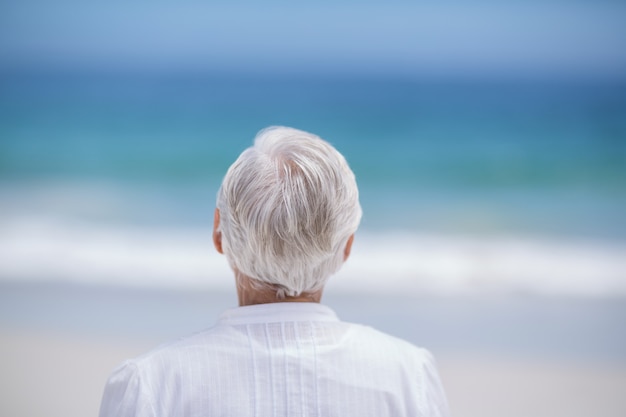 Rear view of mature woman day dreaming