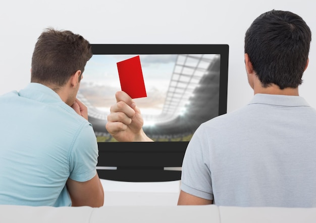 Rear view of men watching television in living room