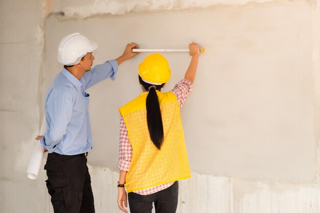 Rear view of men working at construction site