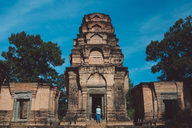 Rear view of mid adult woman standing outside ankor wat temple