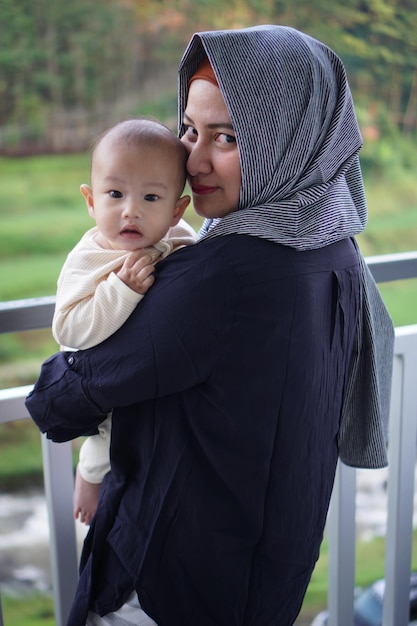 Rear view of mother carrying son