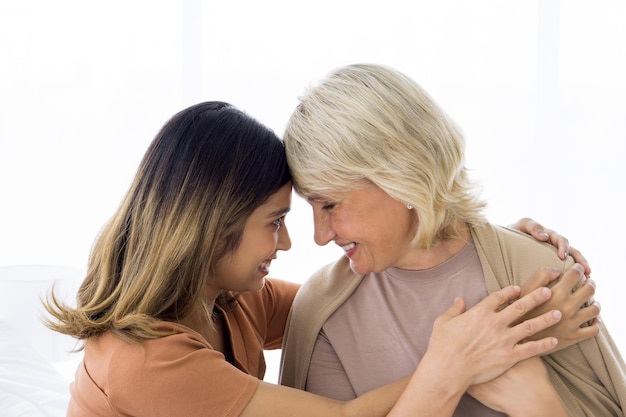 Rear view of mother with daughter against white background