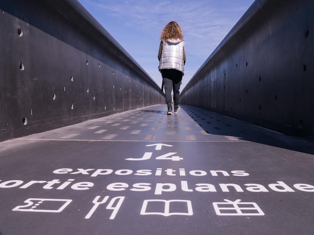 写真 橋の上にある女性の後ろの景色