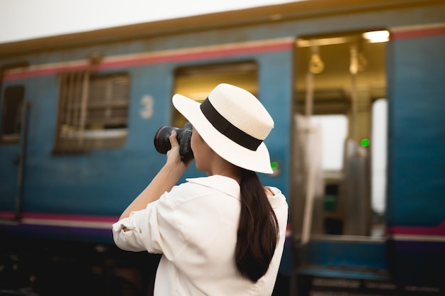 사진 열차 의 카메라 로 사진 을 찍는 여자 의 뒷면