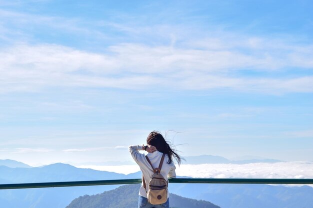 사진 관측 지점 에서 산 을 배경 으로 서 있는 여자 의 뒷면