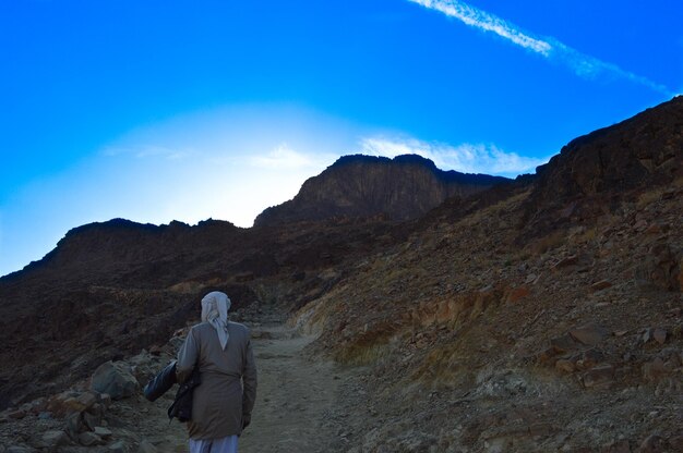 Rear view of our guide on moses mountain against blue sky