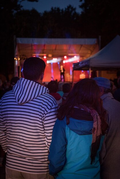 Foto vista posteriore di persone al concerto durante la notte