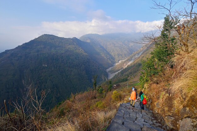 Rear view of people on mountain against sky