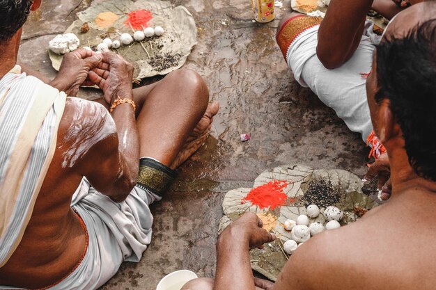 Foto vista posteriore di persone che eseguono rituali all'aperto