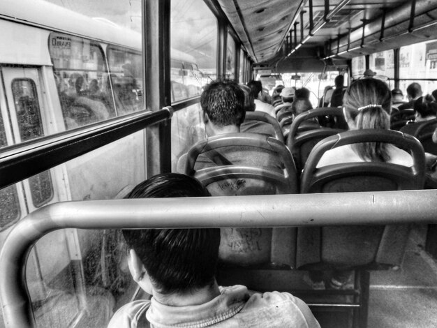 Rear view of people sitting in train