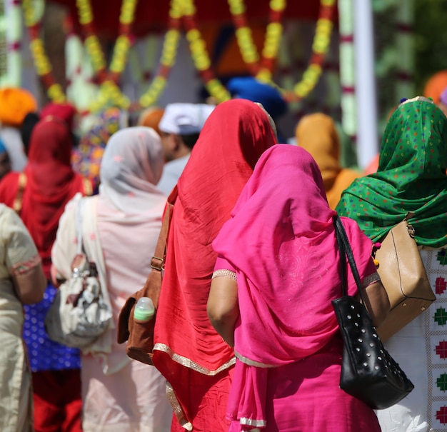 rear view of people standing outdoors during sunny day