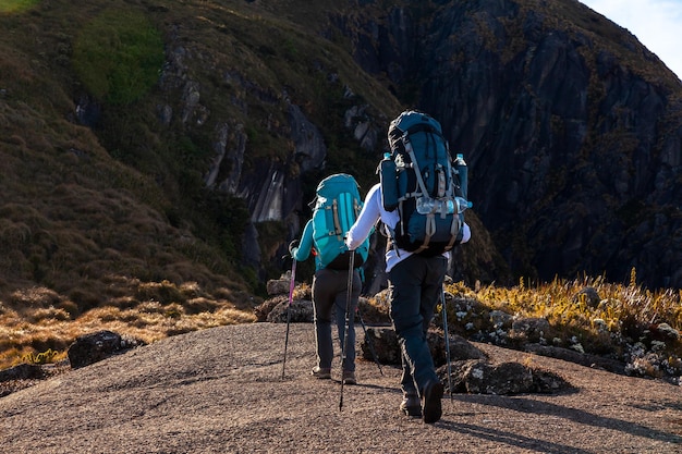 rear view of people walking on rock
