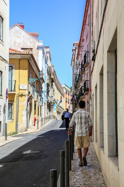Rear view of people walking on street in city