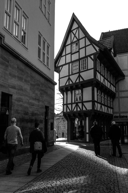 Rear view of people walking on street in city