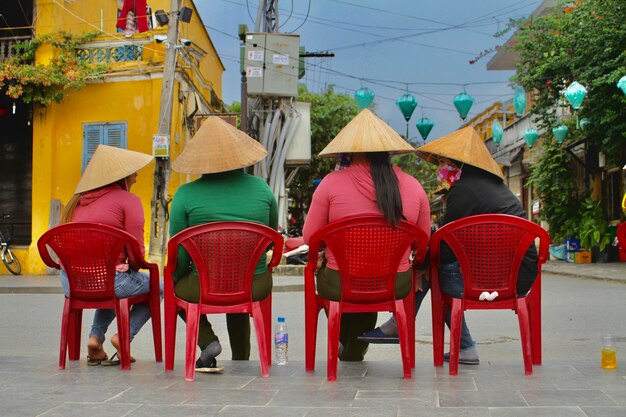 Rear view of people walking on street in city