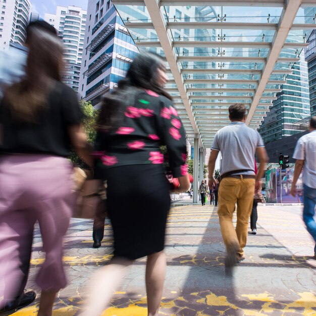 Rear view of people walking on street in city