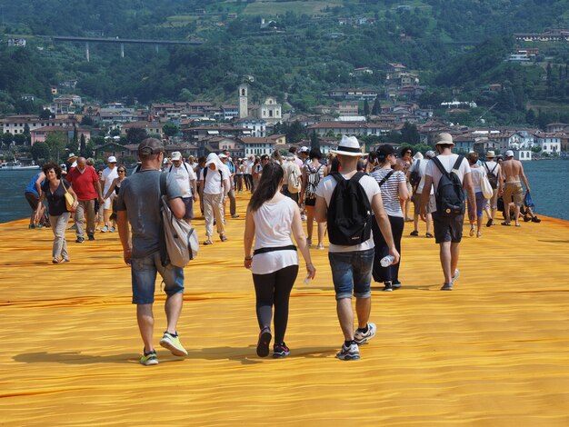 Rear view of people walking on street in city