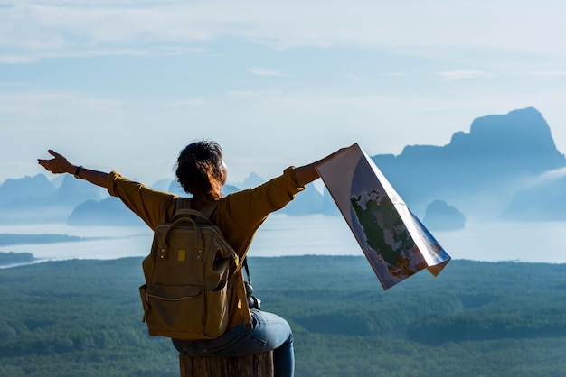 rear view of person standing on mountain against sky