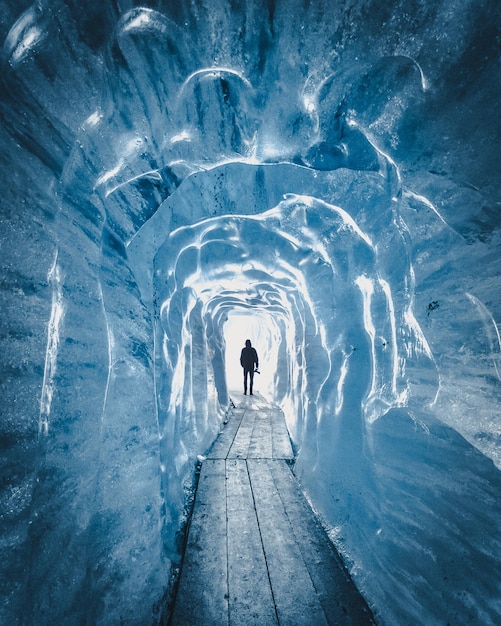 rear view of person standing in snow cave