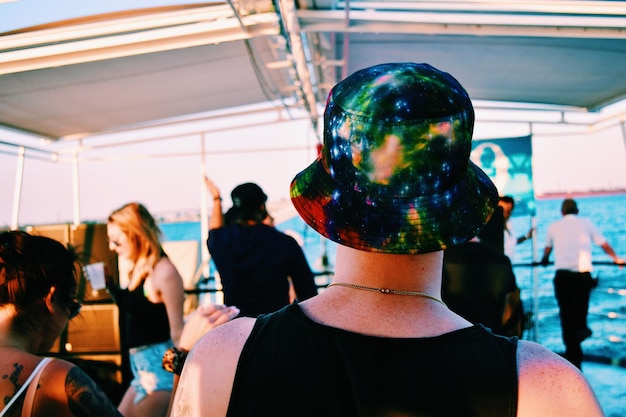 Rear view of person wearing hat in boat