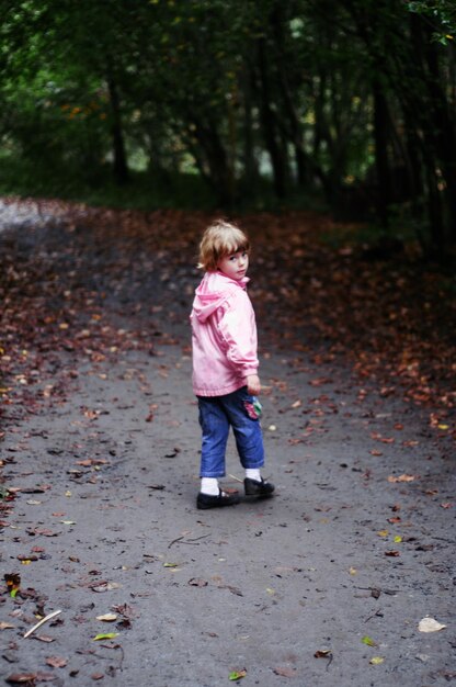 Foto ritratto di una ragazza che cammina sul sentiero durante l'autunno