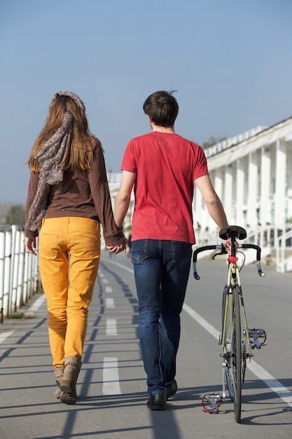 Rear view portrait of a young couple walking outdoors