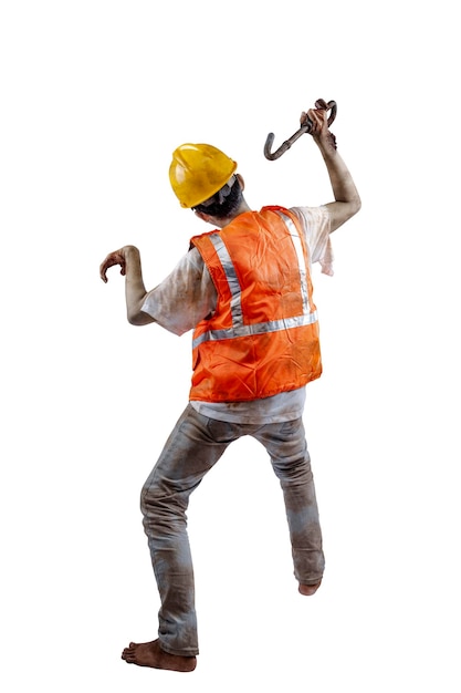 Rear view of a scary construction worker zombie with blood and wounds on his body walking while carrying an iron isolated over a white background