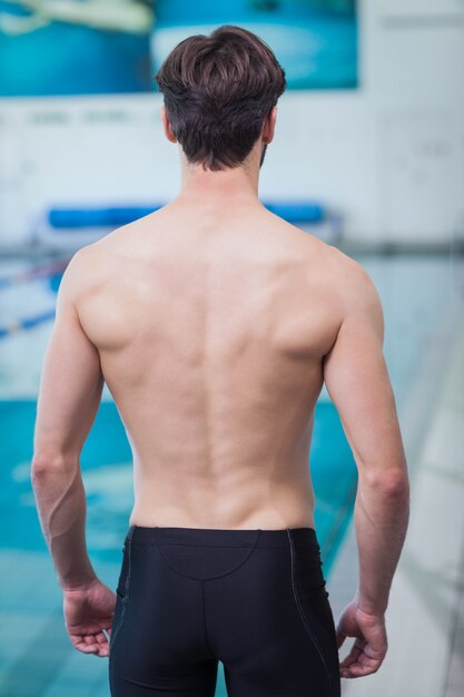 Rear view of shirtless man at the pool